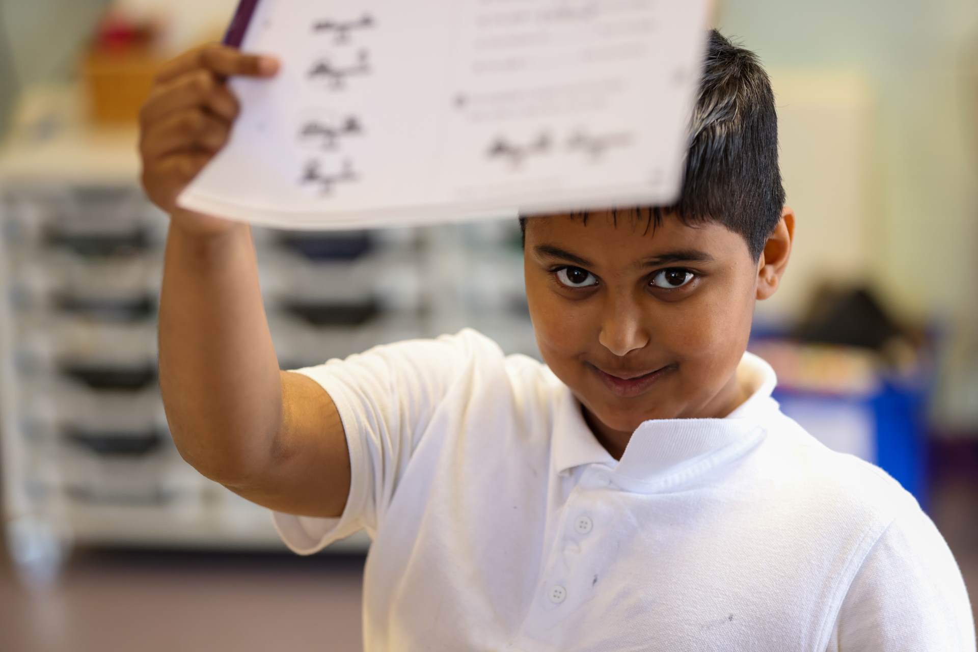 Nur child holding work